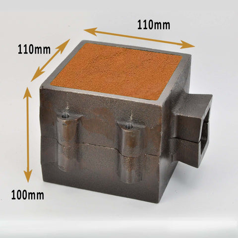 Medium-sized metal casting flask, 110mm wide x 110mm long x 100mm high, with sand molds, used for industrial foundry processes, isolated on white background.