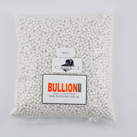 Plastic bag of 4mm white zirconia tumbling media with a '1 Kilo' label and 'BULLIONCARE' branding.