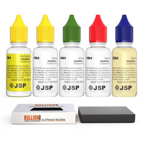 A collection of gold testing solutions with colored caps indicating different karats (9k, 10k, 14k, 18k, 22k) and a 2x2 inch testing stone, branded by JSP and Bullioncare.